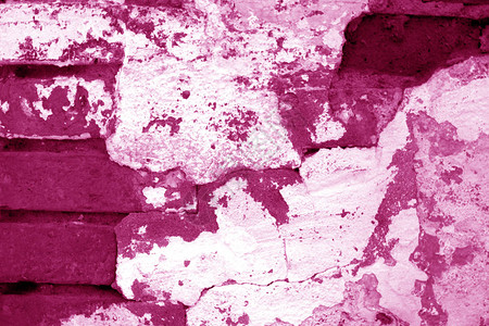 粉红色调的旧又脏臭的砖墙纹理抽象的建筑背图片