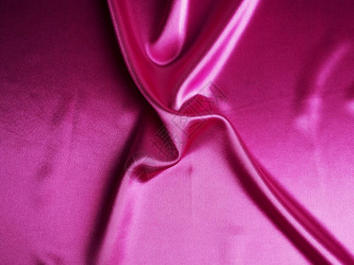 光滑优雅的粉红色丝绸可以用作背景抽象的粉红色丝绸带褶皱的图片