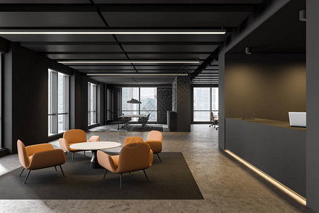 时尚的办公室内部有灰色的墙壁混凝土地板灰色的接待台带橙色扶手椅和咖啡桌的休息区以及背景中的会议室图片