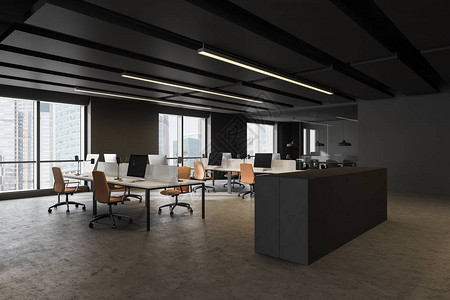 以黑灰墙混凝土楼层白电脑桌排橙色椅子和时装档案柜的开放空间办公图片