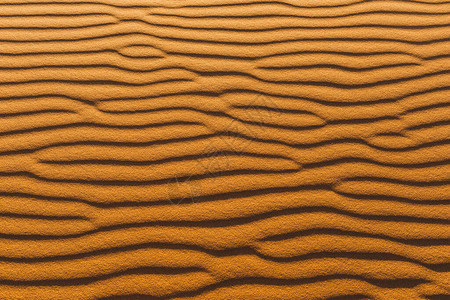 沙丘的橙色纹理抽象形状背景阴影和阳光图片