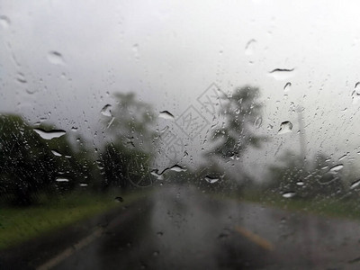 雨季抽象背景下雨滴在汽车玻璃窗上图片