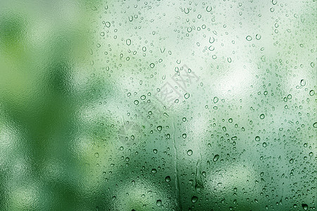 下雨街头唯美绿色雨滴背景设计图片