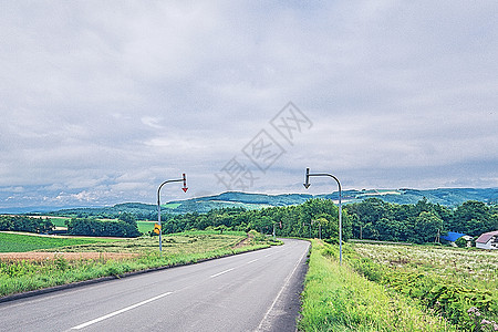 北海道夏天晴空远路和骑车少年背景图片