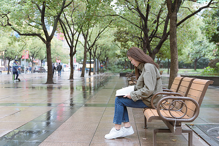 公园里坐着看书的女孩图片