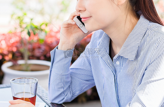 年轻女子在咖啡馆打电话图片