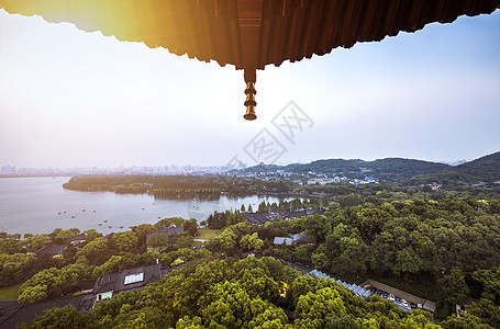 成都景点雷锋塔上眺望杭州西湖夕阳美景背景