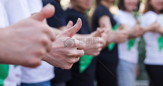 年轻公司团队共同举大拇指图片
