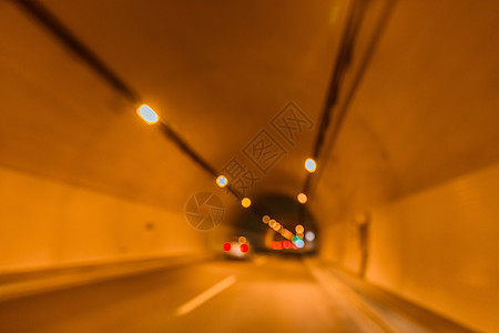 公路隧道灯光车流虚化背景背景图片