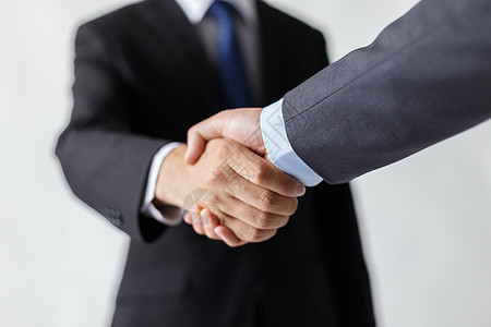 商务合作握手握手的商务人士背景