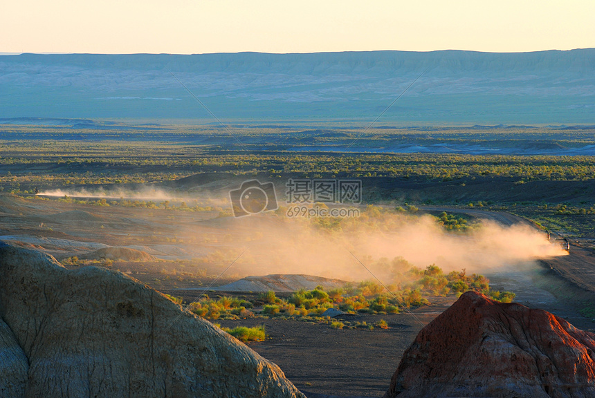 新疆荒漠中尘土飞扬疾驰的越野车图片