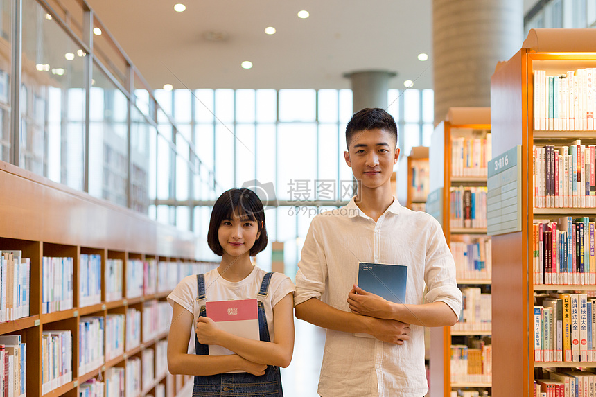 青春男女同学在图书馆学习看书讨论图片