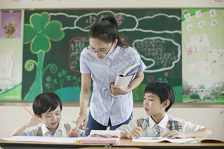 上课时老师在辅导学生认真学习图片