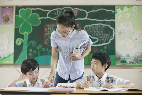 上课时老师在辅导学生认真学习图片