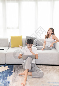年轻夫妻一起在客厅沙发上看电视图片