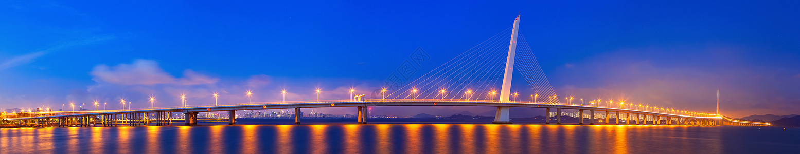 黄色灯光跨海大桥城市夜景背景