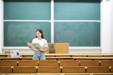 大学课堂坐在黑板前学习的女学生背景