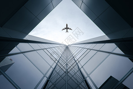 都市飞机飞过高楼设计图片