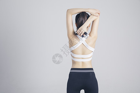 棚拍模特握力器健身的运动女性背景