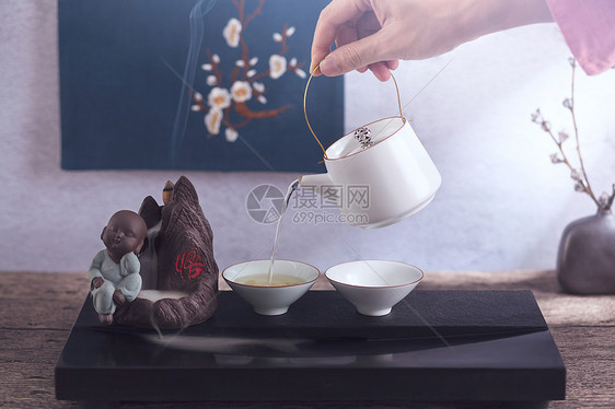 手拿茶壶倒茶图片