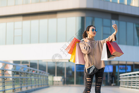 女性手提购物袋消费背景图片