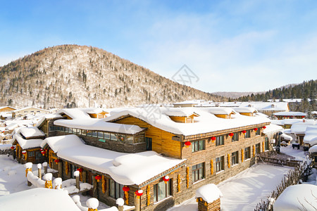 雪山下的村庄冬景图背景图片