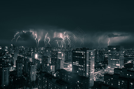 暴风雨乌云下雨闪电下的城市夜景背景