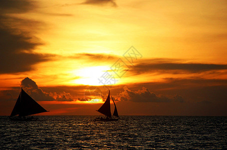 夕阳海滩日落帆船背景