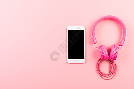 粉色女性耳机手机静物背景图片