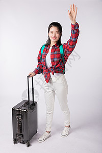 拉着行李的女孩拉着行李箱的年轻女生背景