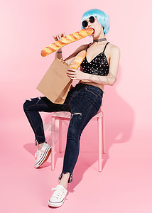 时尚美女霸气坐姿抱着面包袋背景图片