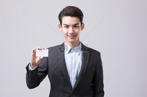 年轻商务男性手持名片图片