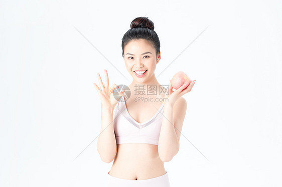 运动健身美女手持苹果图片