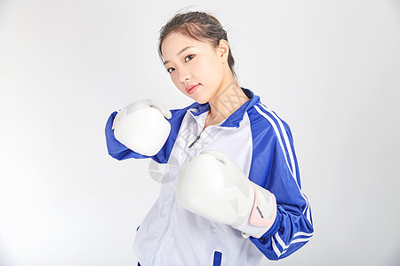 女高中生戴着拳击手套强大力量概念图片
