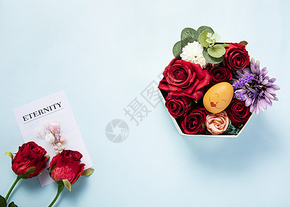 蓝色背景上装满鲜花的礼物盒图片
