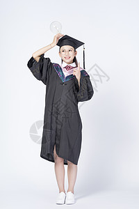 拿着灯泡的毕业女学生图片