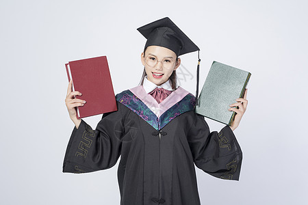 拿着书本的毕业女学生图片