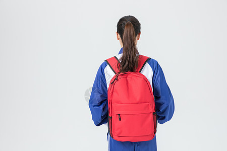 背书包的女性校服学生背影背景图片