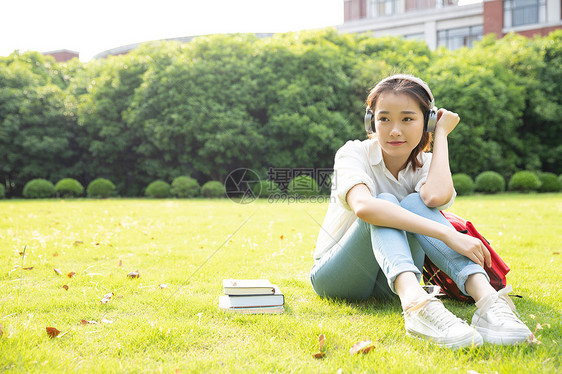 青春学生坐草地上听音乐图片