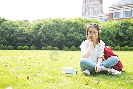 青春学生坐草地上听音乐图片