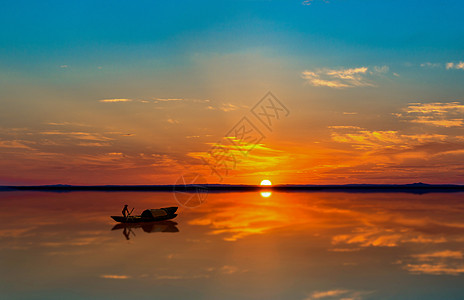 夕阳下的湖泊与小船背景图片