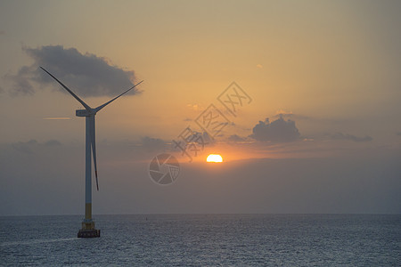 夕阳下的风能发电机图片