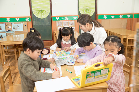 戴眼镜小孩幼儿园老师指导画画背景