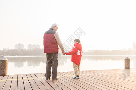 祖孙情夕阳下爷爷牵孙子背影图片