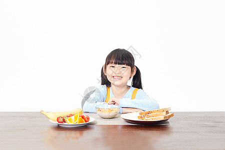 小女孩吃早餐高清图片