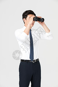 商务男青年使用望远镜远看图片