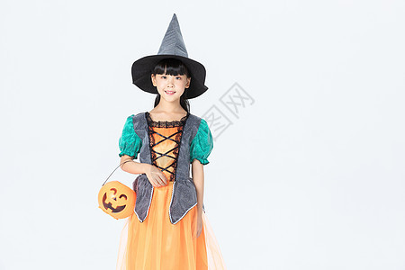 小女孩万圣节女巫打扮拿着南瓜灯图片