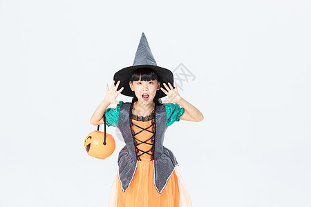 小女孩万圣节女巫打扮拿着南瓜灯背景图片