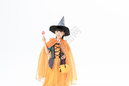 可爱小女孩万圣节女巫打扮拿着南瓜灯和棒棒糖背景图片