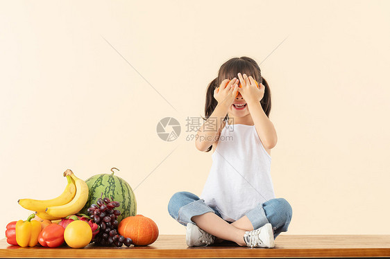 小女孩手拿橙子图片
